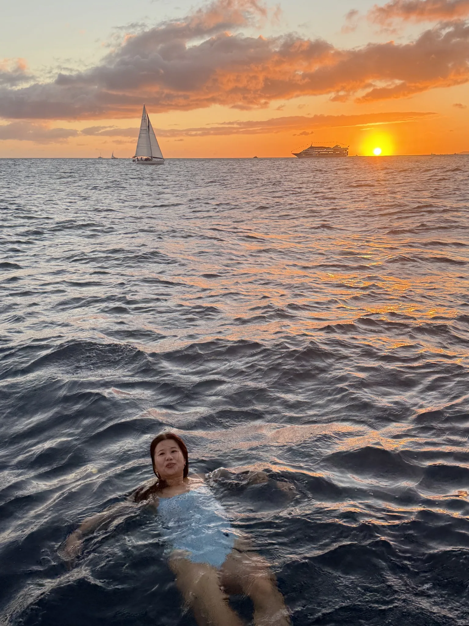 Guest relaxing on the boat with Waikiki in the background
